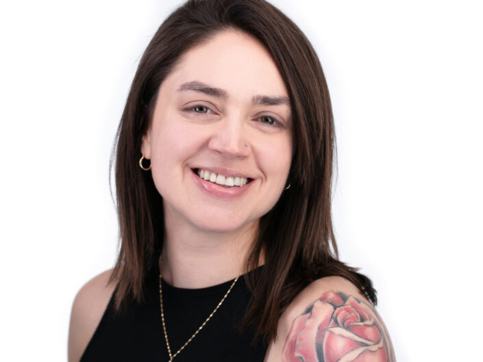 Headshot of woman with rose tattoo