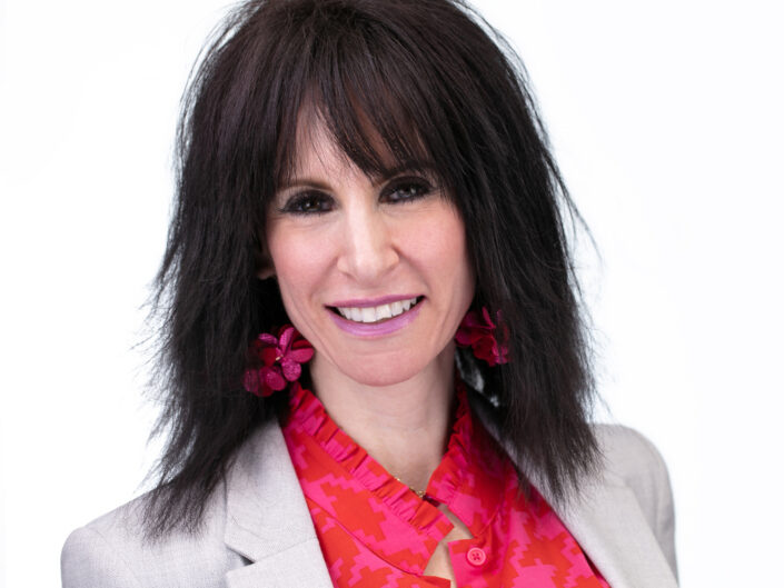 Headshot of woman wearing pink earrings